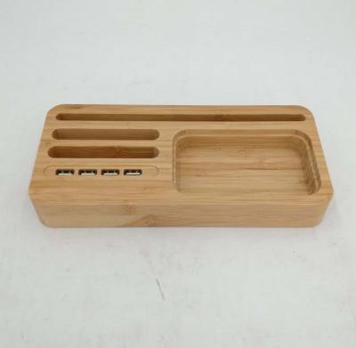 China 4 USB Ports Storage Dock Station Mobile Phone Charger Stand Multifunctional Wooden Bamboo Charging Stand for sale