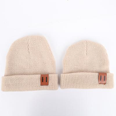 China New JOINT design knitted wool sweater hat for parents and kids Fahion leather warm standard pure color knit baby hat for sale