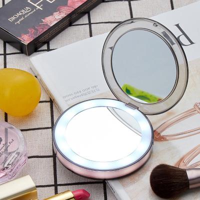 China Round Travel Lighted Cosmetic Mirror Folding Mini Pocket Double Side Mirror for sale