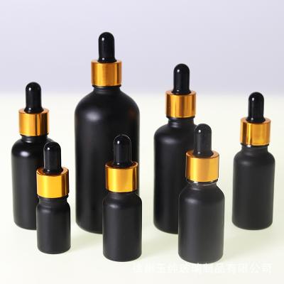 China Personal Care Custom Essential Oil Bottle Creative Black Glass Dropper Bottle Packaging For Cosmetics for sale