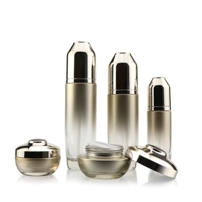 China New Design Cosmetic 40 Gold 110 130ml Empty Customize Cosmetic Glass Bottle Pump Cosmetic Glass Bottle With Gold Lids for sale