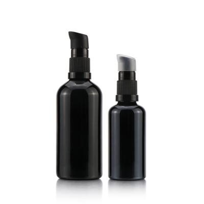 China Cosmetic Custom Black Cap Round UV Dark Violet Cosmetic Glass Bottle With Lotion Pump for sale