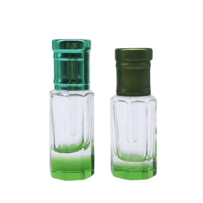 China Personal Care Fancy Tola Octagonal Bottle For Oud Green Crystal Base Attar Essential Oil Bottles With Glass Stick for sale