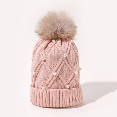 China Waterproof New Women Personality Wild Female Fur Pom Poms Hats Beanie High Quality Winter Warm Bonnet Outdoor Riding Windproof Knit hat for sale