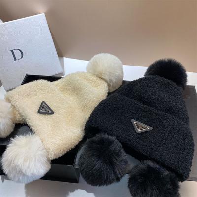 China COMMON Autumn and winter warm polar fleece encrypted knitted earmuff European and American cute fur ball lambswool pullover hat women for sale