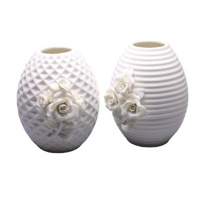 China Traditional Chinese Decorative Tableware White Ceramic Vase With Embossed Flowers for sale