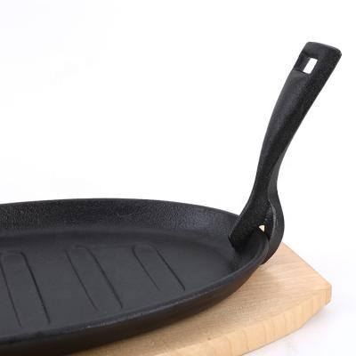 China Sustainable Cookware Cast Iron Sizzling Pan Sizzling Hot Plate With Wooden Base for sale