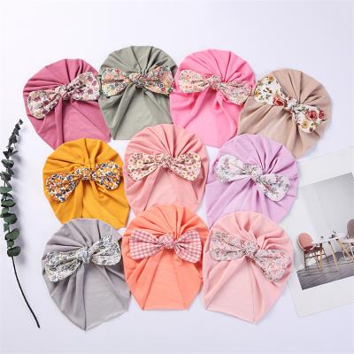 China New Style Cheap Wholesale Casual Hats Baby Kids Stretchable Newborn Milk Silk Printed Bow Knot Cowl Infant Turban Turban for sale