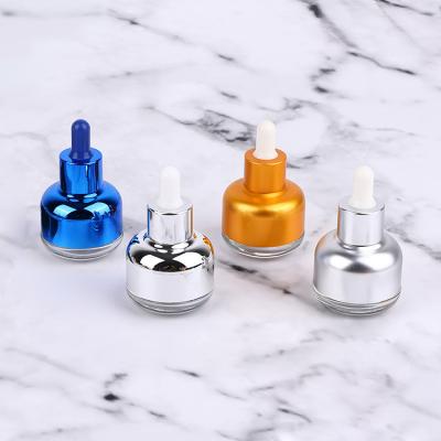 China Luxury Cosmetic Silver Blue Aluminum Cover Essential Oil Cosmetic Serum Gold 30ml Dropper Glass Bottle for sale