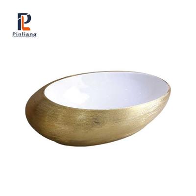 China Scratch Proof Design Art White Basin Electroplate Gold Nice Ceramic Oval Countertop Wash Hand Basin Gold Bathroom Sinks for sale