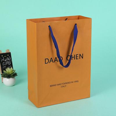 China Gold Stamp Famous Brand Recyclable Sustainable Recycled Orange Paper Shopping Bags With Satin for sale