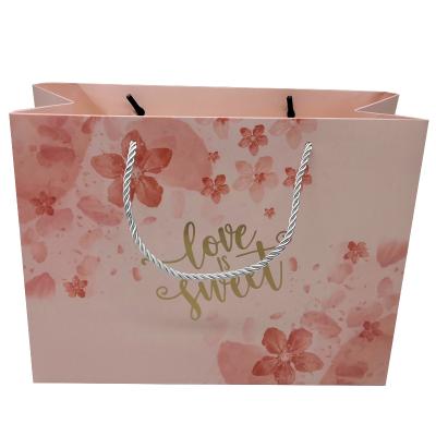 China Recyclable wholesale gold logo gift shopping clothing store pink small paper bag shopping paper bag with rope handle for sale