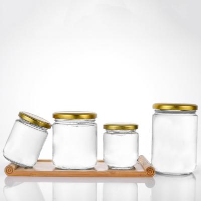 China Promotional Wholesale Price Food Round Clear Glass Jar For Jam, Honey And Pickles With Gold Metal Lid for sale