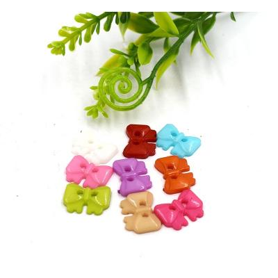 China Viable Low Price Multicolor Bowknot Shaped Plastic Button For Children's Coat DIY Handwork for sale