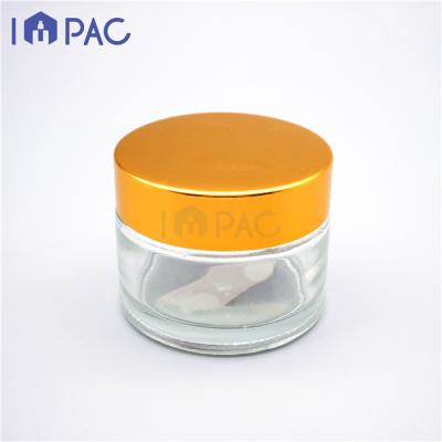 China Glass Jar 50ml Cosmetic Shiny Gold Transparent Empty Cream Cap For Face for sale