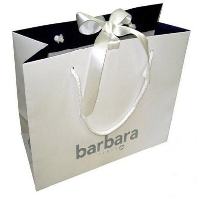 China Recyclable Luxurious Clothing Kraft Paper Bag Printed With Ribbon Closed for sale