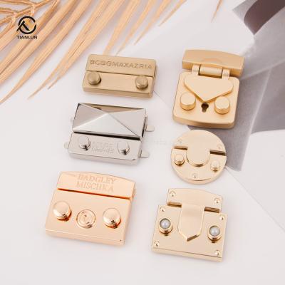 China Eco-friendly Designer Bag Hardware Metal Buckle Lock Customize Logo Push Lock Clasp Handbag Hardware Shoulder Bag Lock for sale