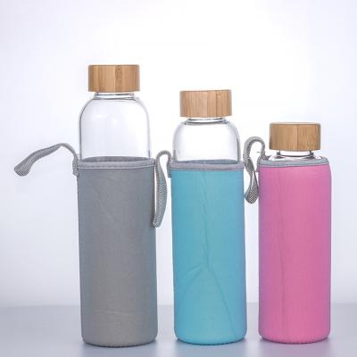 China Sustainable high quality cost effective eco friendly bamboo and metal lid glass water bottle with leather sleeve for sale