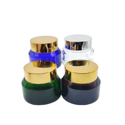 China Cosmetic 30g clear/amber/green/blue Oblique Shoulder Body Cream Glass Cosmetic Packing Jar Containers for sale