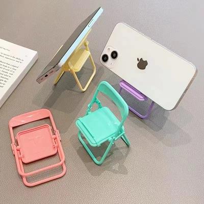 China Adjustable Cute Chair Shape Adjustable Foldable Portable Plastic Cell Phone Display Stand For Watching TV Phone Lazy Bracket Bracket for sale