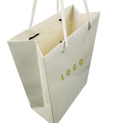 China Recyclable custom logo art paper gift package printed paper bags boutique shopping bag with black ribbon handle for sale