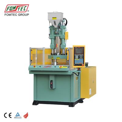 China VERTICAL FOMTEC 600 kN rotary table injection molding machine vertical plastic injection molding machine mobile loader making machine for sale