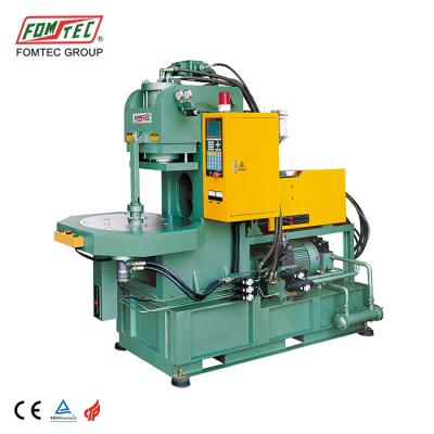 China VERTICAL injection molding machine 450kN tie rod less grip vertical injection molding machine rotary table plastic injection machine for sale