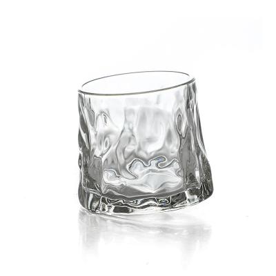 China Modern Creative Rotating Foreign Spirits Beer Wine Hammer Pattern Tumbler Glass Whiskey Glass for sale