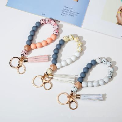 China 2022 Key Holder Fashion Multi Color Silicone Beads Leather Elastic Bracelet Tassel Key Chain for sale