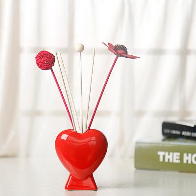 China Novelty Wedding Perfume Empty Tubular Ceramic Aroma Diffuser Bottle Red Color Decorative Heart Shaped Diffuser Vase Bottle for sale