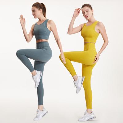 China Women's One Color Breathable Clothing Sports Upper And High Waisted Workout Leggings Yoga Sets Fitness Sports Bra Gym Pants With Pockets for sale