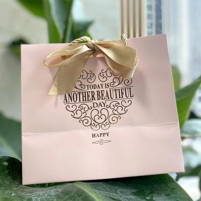 China Recyclable Customized Logo Printed Gift Bag Packaging Paper Bags For Clothing for sale