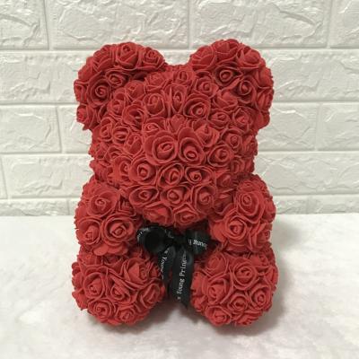 China New Durable Artificial Pe Moss Eternal Rose Teddy Bear Hold Rose for sale