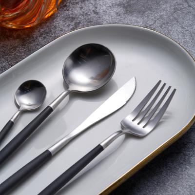 China Durable Portugal Silver Rose Handle Resin P001 Stainless Steel Black White Cutlery Set for sale