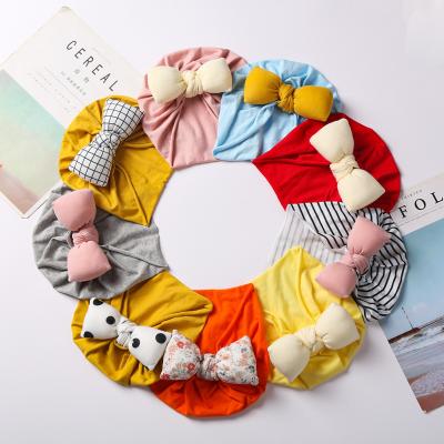 China XUFANG Dobby Hot Sale Fashion Children Covers Hood Colorful Bow Baby Turban Soft And Comfortable Cotton Filled Hats for sale