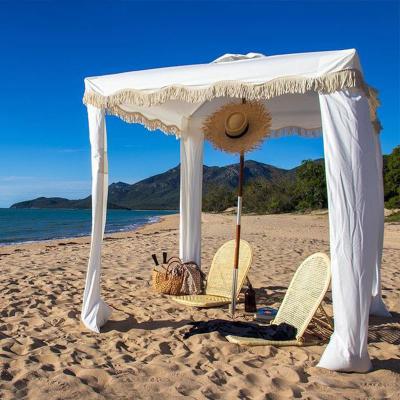 China Modern Outdoor Premium Canvas Fringe Sun Shelter Beach Shade Hut With Tassels Poles Portable Wooden Cool Beach Umbrella Hut Tents for sale