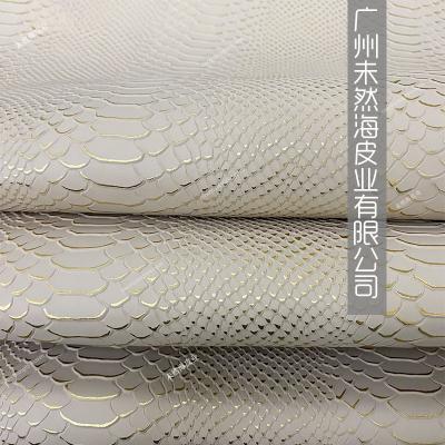 China Wrinkle Resistant Gold Python Pattern Cowhide Sliced ​​Version Embossed Upper Layer Golden Whole Leather Boots Bag New Version for sale