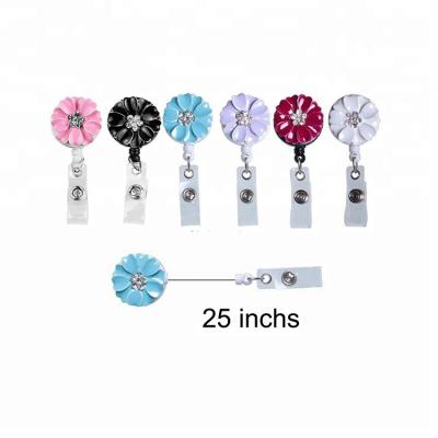 China We can OEM. Camellia badge 360 ​​degree rotation retractable twirl for sale