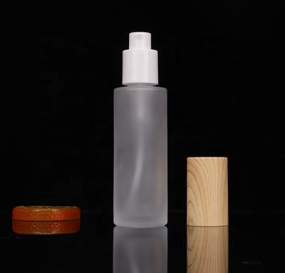 China Personal Care Empty Eco Friendly Bulk Frosted White Glass Body 4 Ounce Lotion Bottle With Pump Dispenser And Wooden Lid for sale