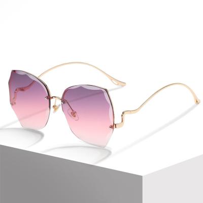 China High Quality Ladies Fashion Sun Glasses Irregular Rimless Plastic Uv400 Lens Sunglasses for sale