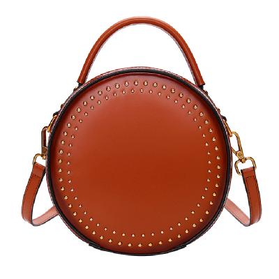 China Fashion Fashion Design Cross - Body Handbag Pure Color Rivet Round Shoulder Bag For Women for sale