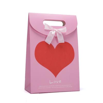 China 2021 Customs Recyclable Pink Printing Take Away Shopping Paper Bag With Ribbon for sale