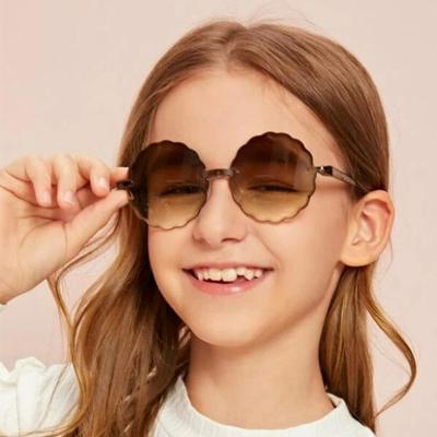 China Protect eyes wholesale personality colorful frameless polygon sunglasses designer candy circle plastic kids sunglasses 2021 for sale