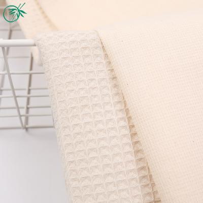 China Viable hot sale stocklot dyed pattern solid woven 100% raw cotton waffle fabric materia for sale