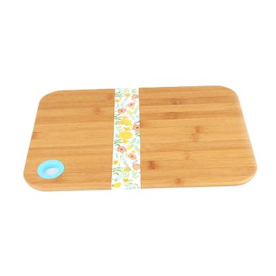 China Kitchen Sustainable Portable Bamboo Cutting Board Chopper With Silicone Hanging Hole for sale