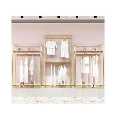 China Display Products To Attract Customers And Promot Sales Gold Clothing Store Interior Design Counter Decoration Design Modern Store Display Clothing Rack for sale