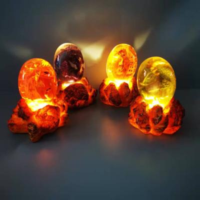 China Europe 2022 New Amazon Hot Sales Light Up Dinosaur Eggs Resin Decoration Opens Souvenir Gifts Lava Dragon Eggs Led Glowing for sale