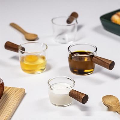 China Heatable Milk Cup Creamer Jug Glass Wood Handle Syrup Sauce Dispenser Espresso Measuring Cup Container Heat Resistant Cup For Home for sale