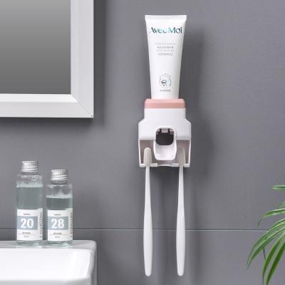 China Creative Wall Mounted Automatic Toothpaste Dispenser Toothpaste Squeezer Toothbrush Holder Bathroom Accessories Storage Racks for sale