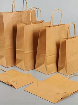 China Custom Logo Lightweight Paper Packing Bag With Square Bottom And Twisted Handle for sale